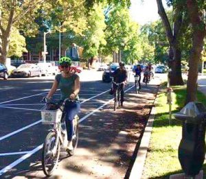 Cyclists ride down a bike lane.