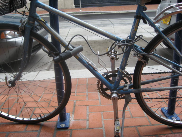 A bike locked to a rack with a U-lock.