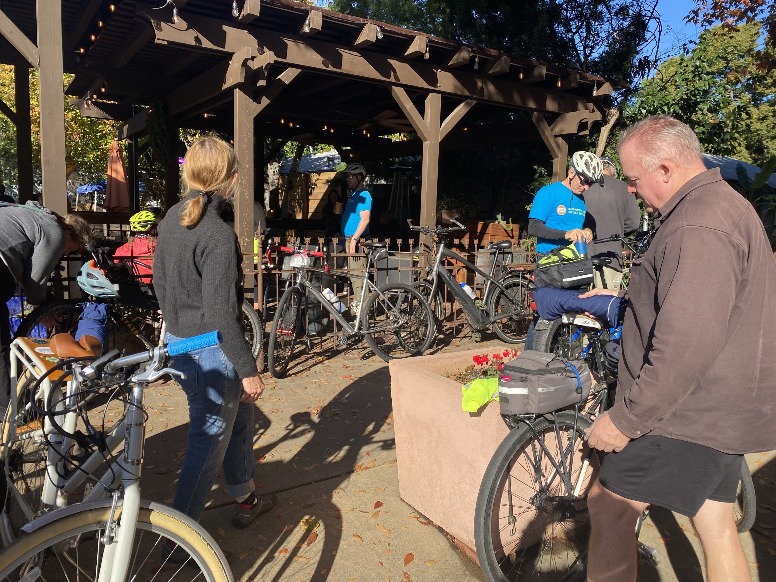 People and bikes outside of a cafe.