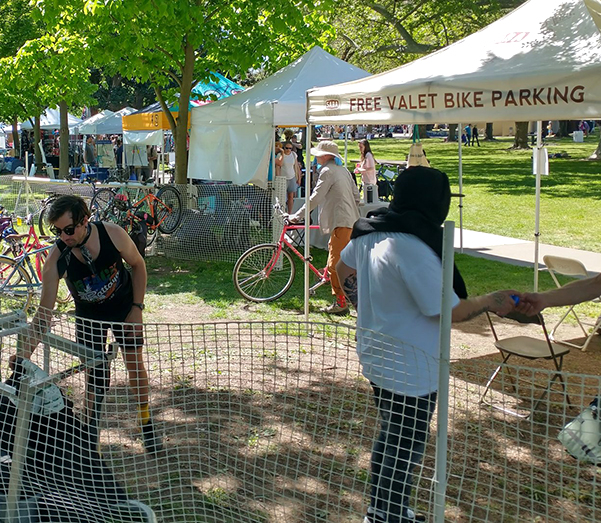 Two people work at a bike valet.