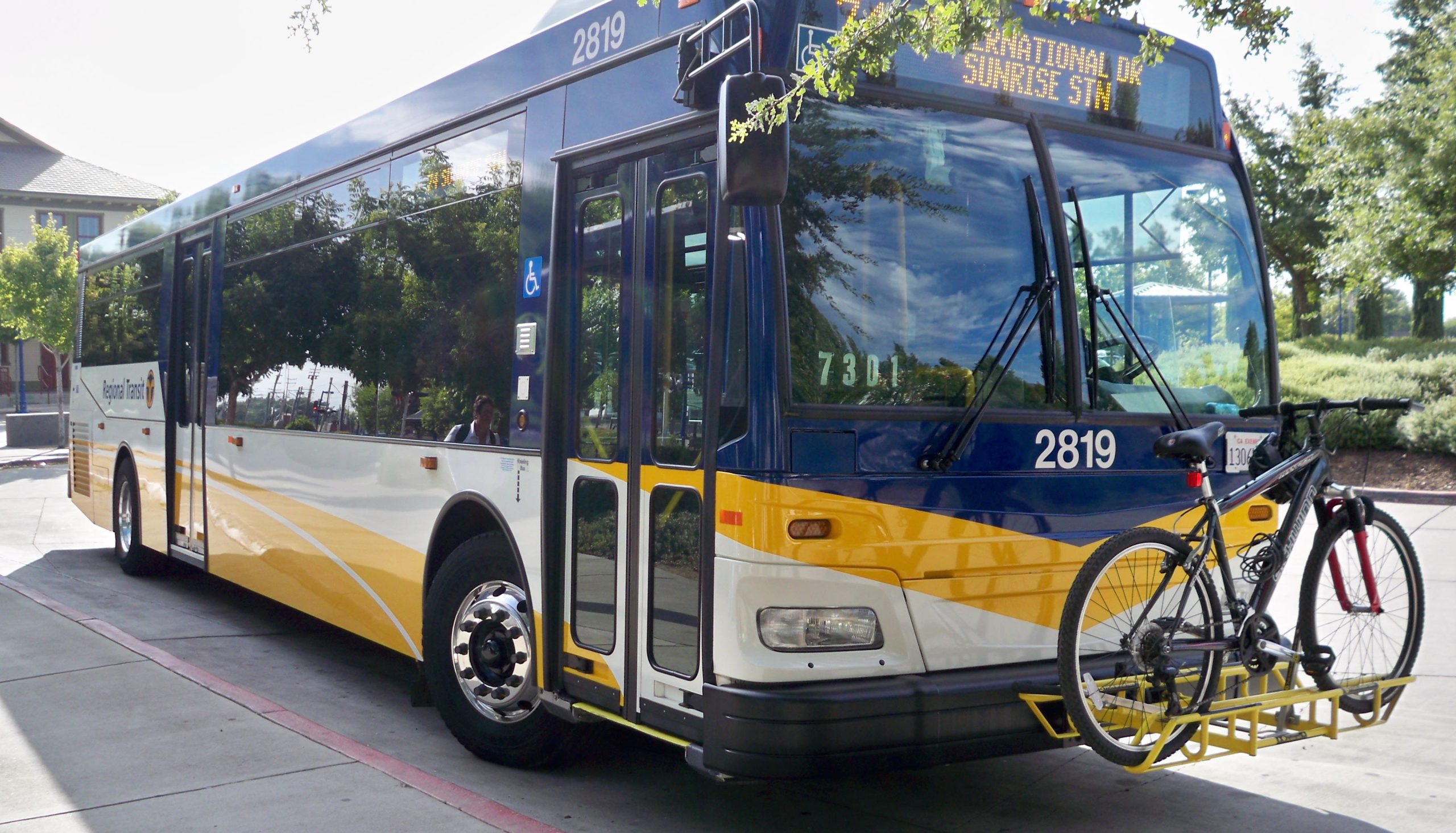 A bus with a bicycle on the front rack.