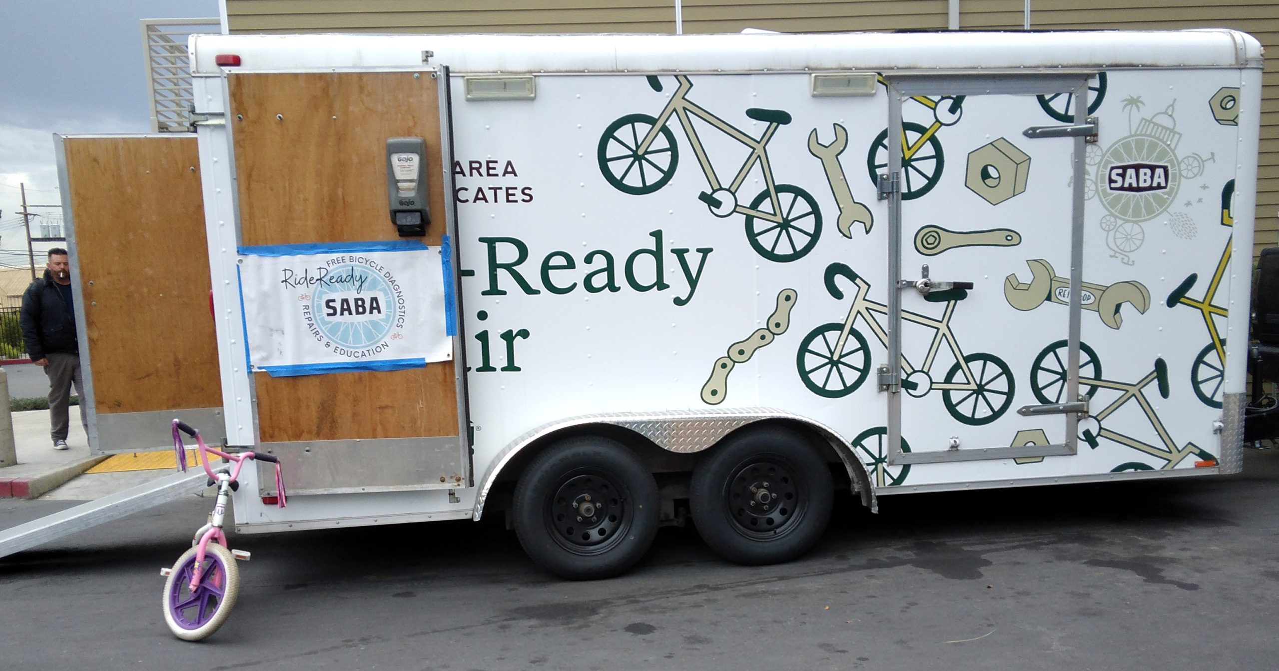 Large trailer with bikes and tools on the side that says "Ride Ready Repair."