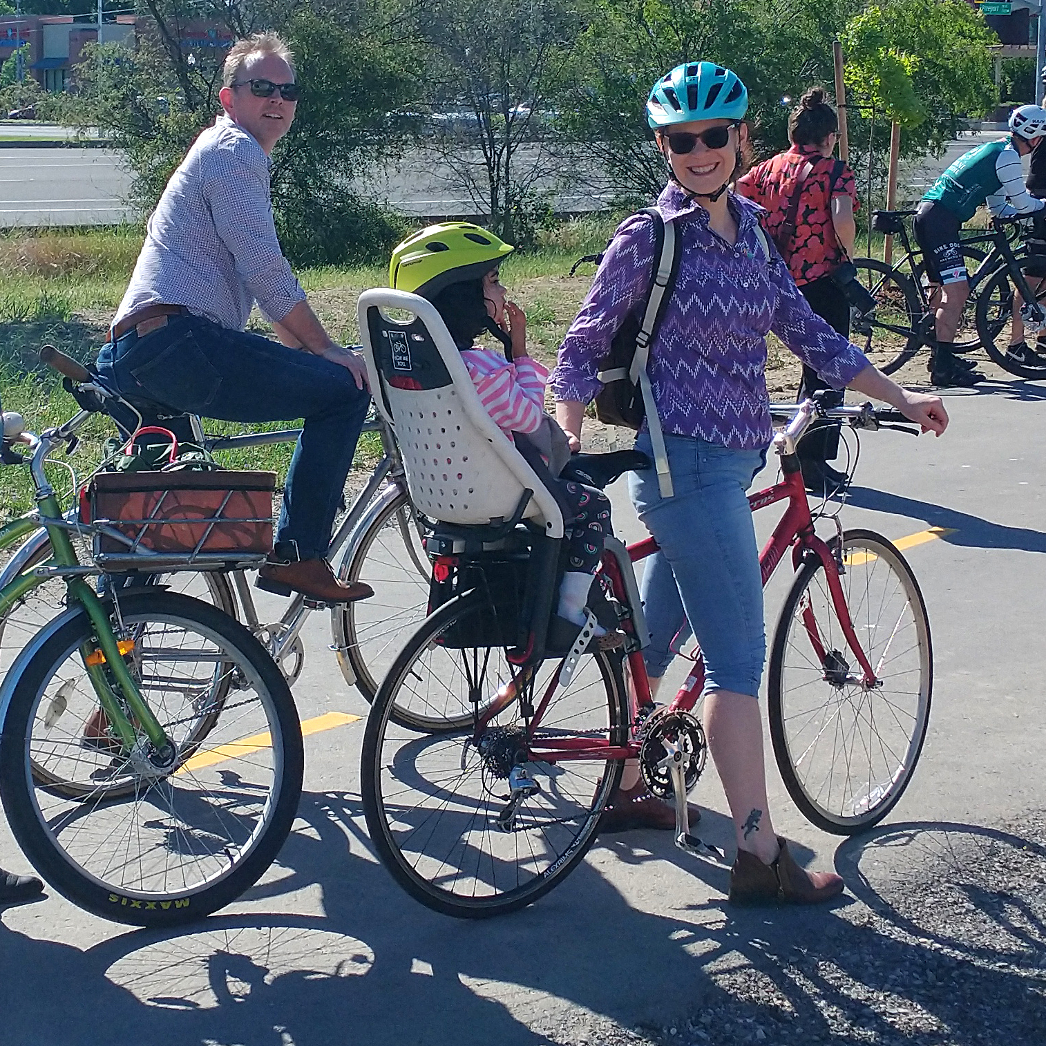 On the bike trail: A man on a bike and a woman and child on a bike