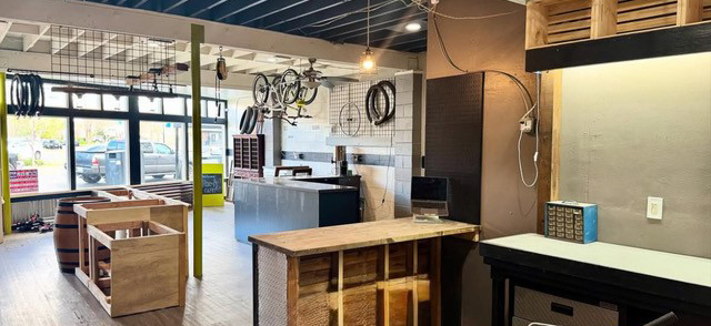 A shop with workbenches and bicycles.
