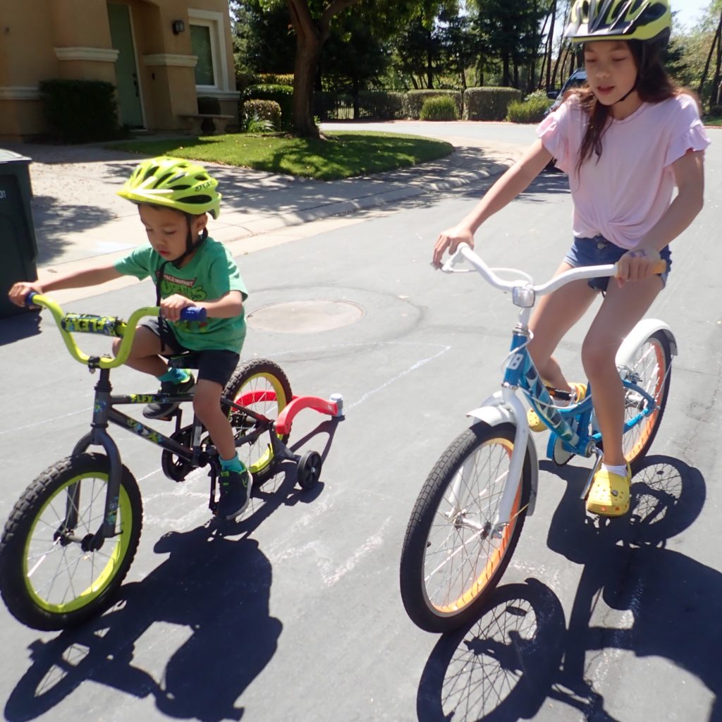 Two children riding bikes.